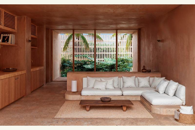 Ahau Gardens Villa 2: corner sofa facing a wide window