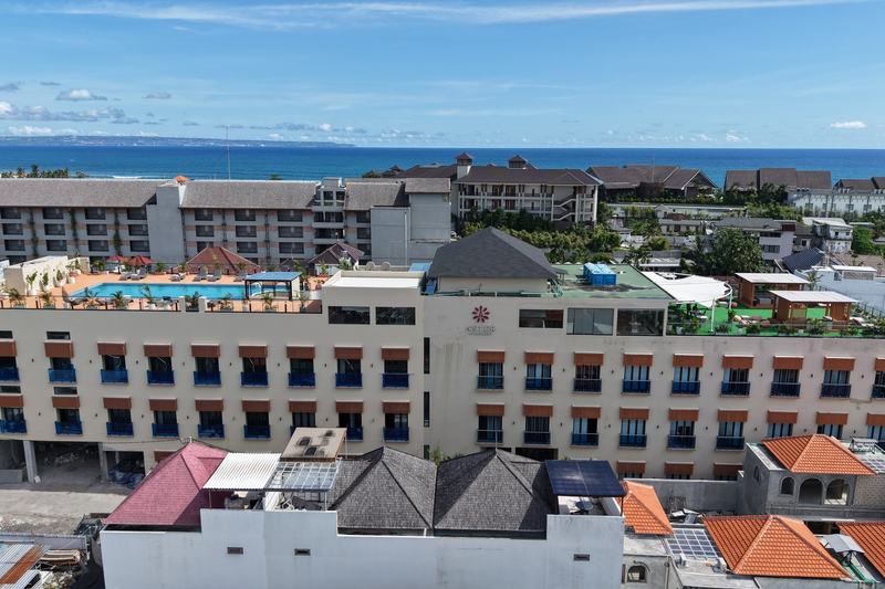 Aster Apartment: the building from above, with the ocean behind