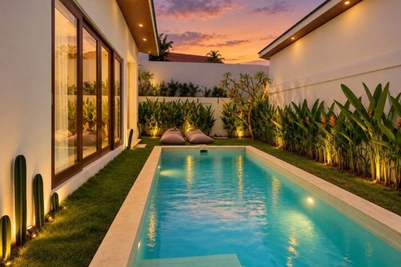 Balangan two-bedroom villa: pool running along the garden at sunset