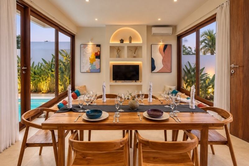 Balangan two-bedroom villa: dining table beside floor-to-ceiling windows