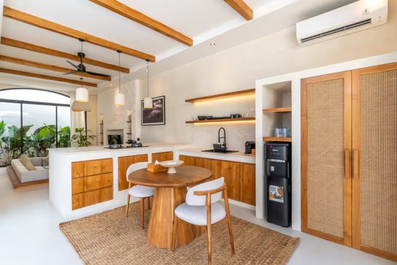 Sunken-lounge villa, Bingin: timber kitchen and round dining table