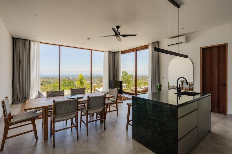 Sunset-view villa in Bingin: living and dining room with full-height windows