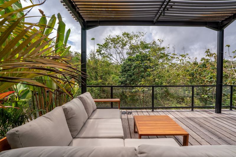 Garden villa in Bingin: covered terrace with a sofa and greenery