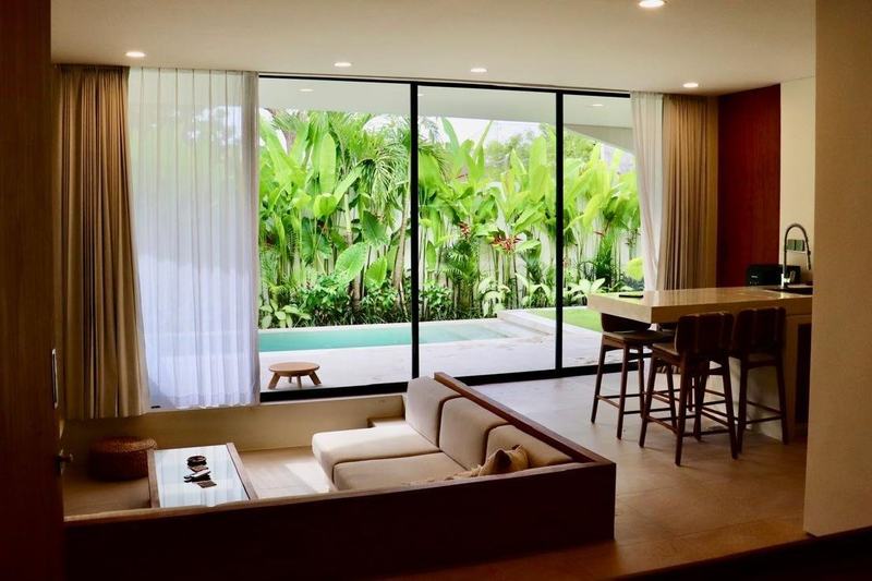 Bingin garden villa, two bedrooms: living room with a corner sofa opening to the pool