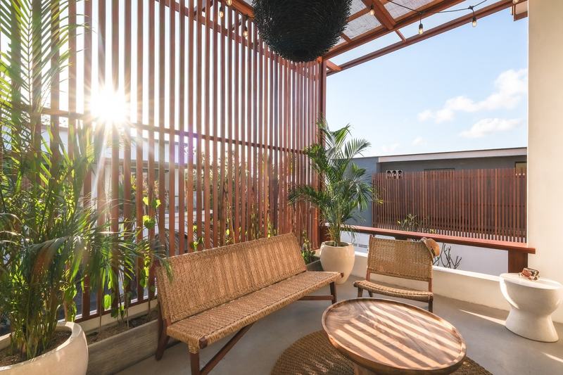 Two-bedroom villa with a louvered terrace, Bingin: terrace with wicker furniture behind wooden louvers