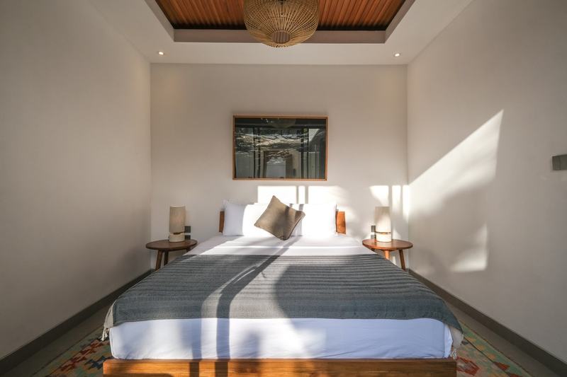 Two-bedroom villa with a louvered terrace, Bingin: bedroom with a painting above the bed