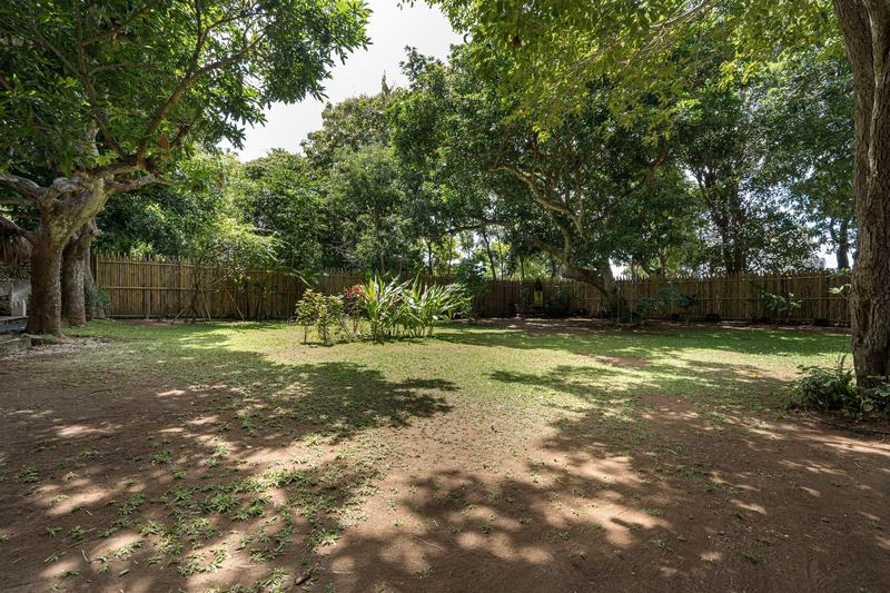 Three-bedroom villa with a garden in Bingin: large shaded garden with a lawn