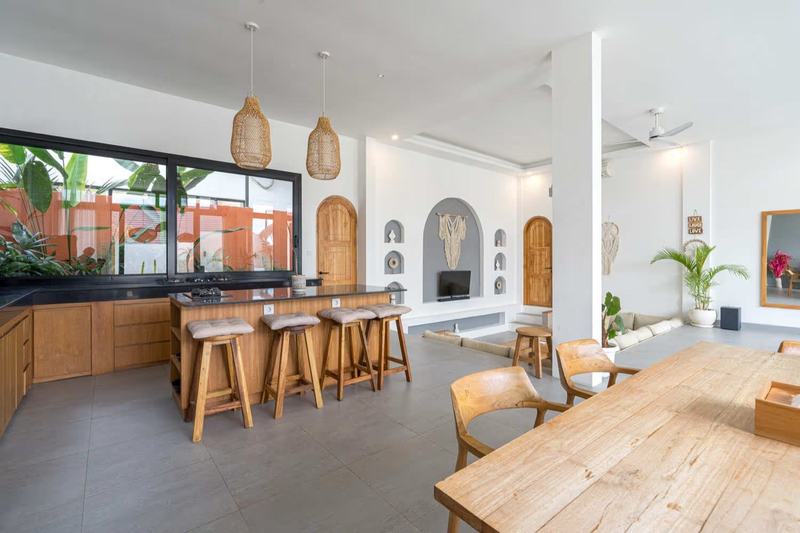 Two-story villa in Bingin: kitchen counter and dining area under woven pendant lights