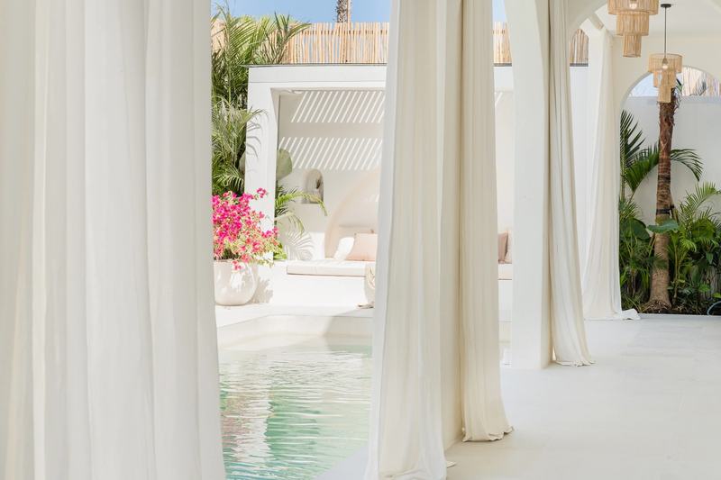 Mediterranean-style villa in Bingin: living room behind light curtains by the pool