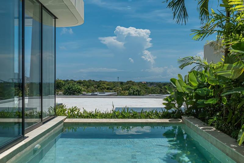 Three-bedroom villa in Bingin: pool and loungers seen from the garden