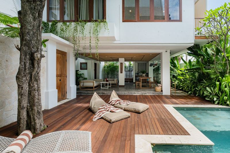 Three-bedroom villa with a wooden deck in Bingin: timber terrace and pool in the courtyard
