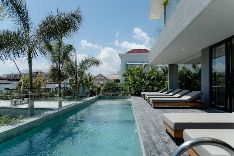 Berawa one-bedroom apartment: shared terrace pool with loungers