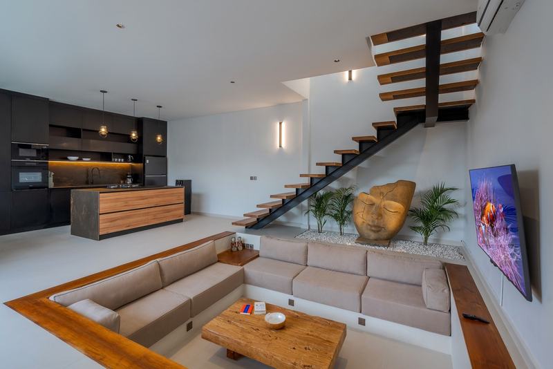 Three-bedroom villa in Padonan, Canggu: living room with a sunken sofa and stairs