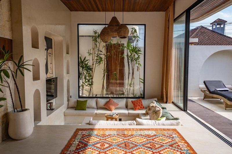 Central Canggu three-bedroom villa: sunken lounge with the garden behind glass