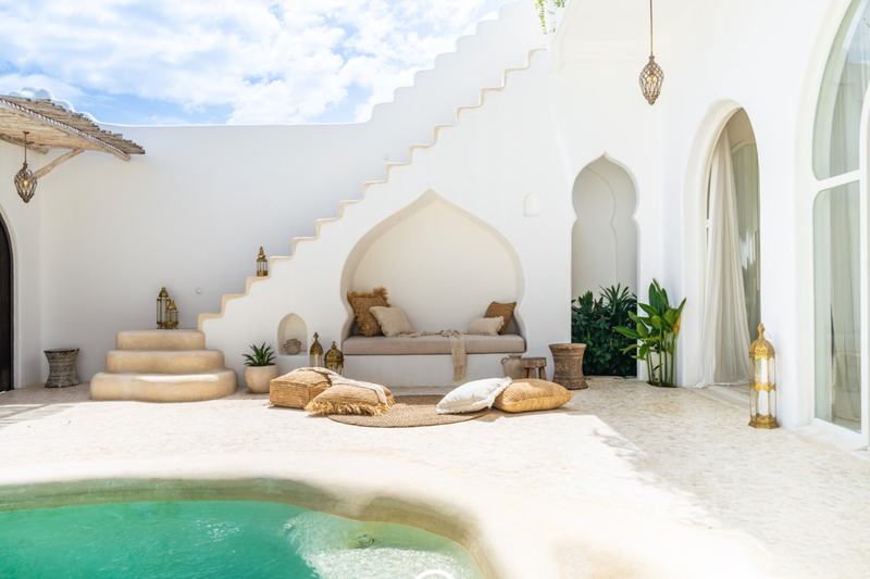 Casa Kayana: courtyard pool, stairs to the roof and a built-in sofa nook