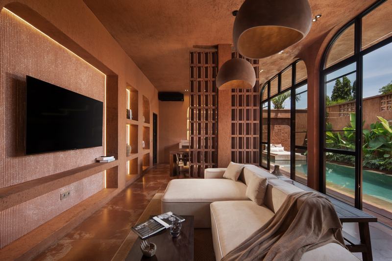 Emy Terra: villa living room with a tall window onto the pool