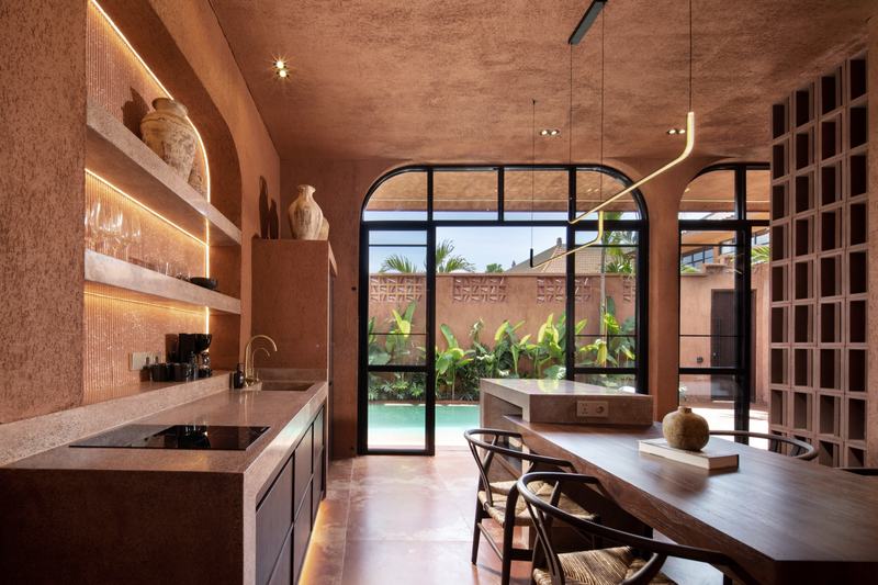 Emy Terra: villa kitchen with a stone island and dining table