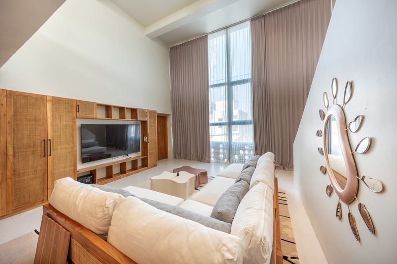 Gate 11 mezzanine: living room with a two-story window