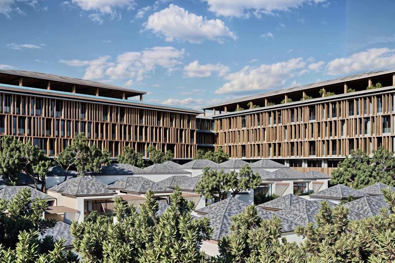 Green Village: apartment buildings rising behind villa roofs (render)