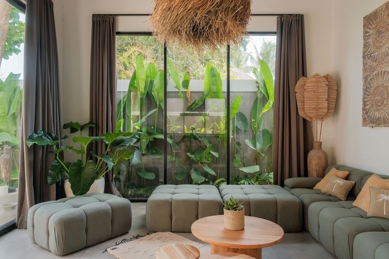 Four-bedroom Kedungu villa: sofa and garden windows
