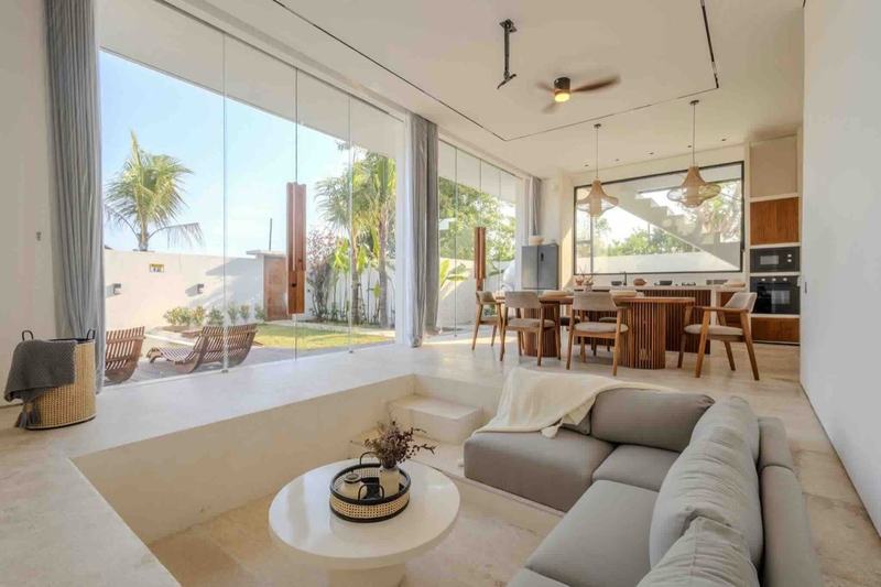 Three-bedroom villa in Melasti: living room with a sunken sofa opening to the garden