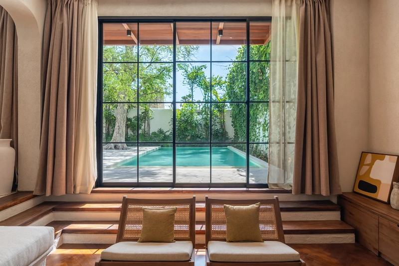 Nila Residence: living room facing the pool