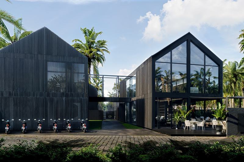 Noir Ubud: gabled villa facade with full-height glazing, render