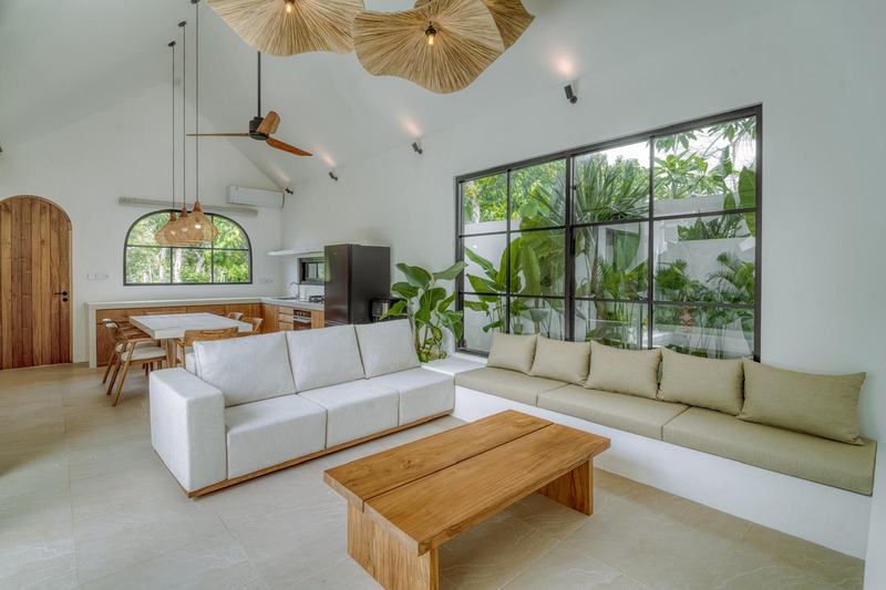 New Pecatu villa: sofa and full-height windows to the garden