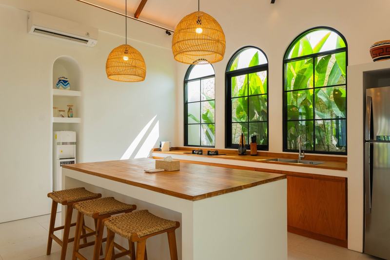 Pecatu three-bedroom villa: kitchen island with bar stools