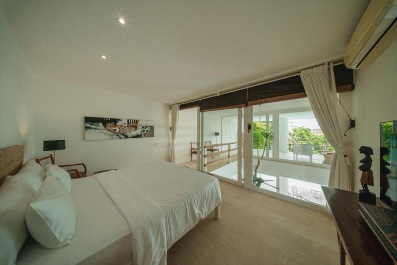 Beachside five-bedroom villa in Pererenan: bedroom opening to a balcony