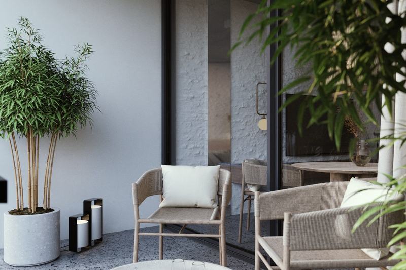 Taras studia 25,7 m² z fotelami i kamiennym stolikiem, wizualizacja dewelopera