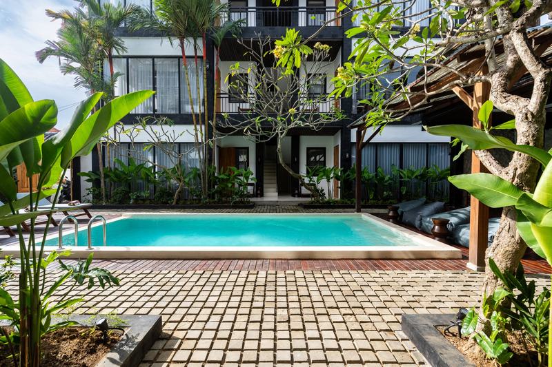 Sebelas Apartments: courtyard pool in front of the three-story block, developer photo