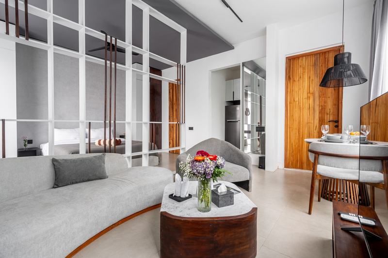 Sebelas Apartments: living room with sofa and dining table, developer photo
