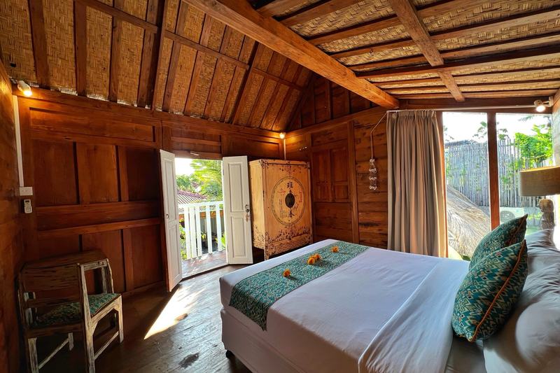 Four-bedroom villa in Seminyak: bedroom under a timber roof