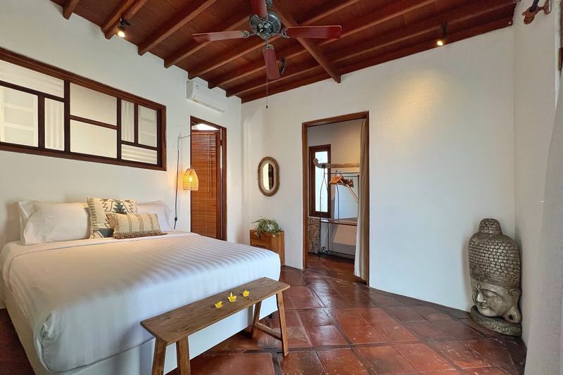 Six-bedroom villa in Seminyak: bedroom under a wooden ceiling