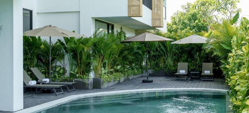 Sunny Aparts I: courtyard pool with loungers and umbrellas, developer photo