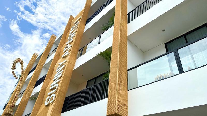 Sunny Aparts I: four-story facade with signage and balconies, developer photo