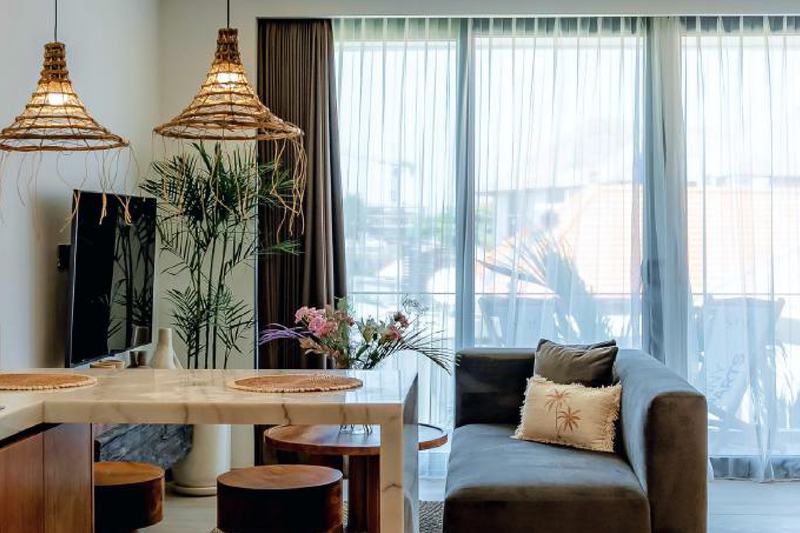 Sunny Aparts II: studio with a dining table beside a wide window, developer photo
