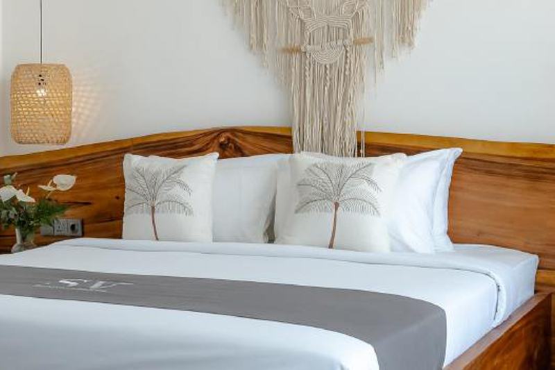 Sunny Aparts II: teak bed in the studio's sleeping zone, developer photo