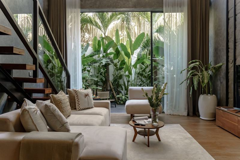 Sunny Cuddles: living room with stairs up and doors to the garden, developer photo