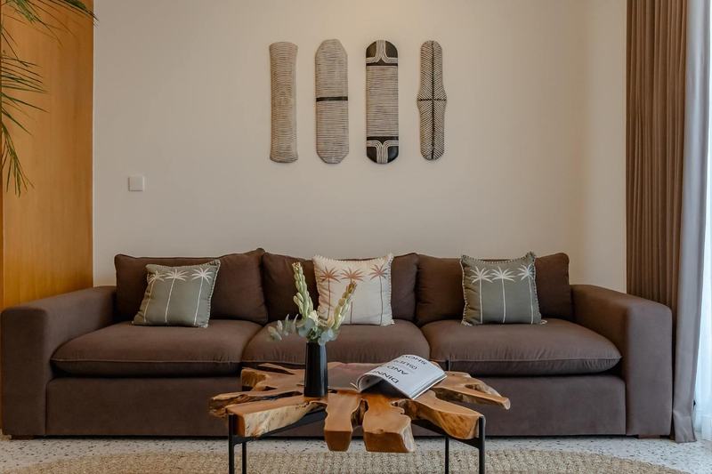 Sunny Nine: sofa and a tree-root coffee table in the living room, from the developer's presentation