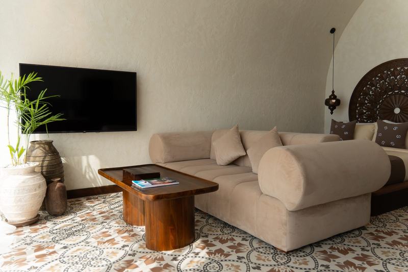 Sunny Samudra: apartment lounge with a sofa and carved wall panel