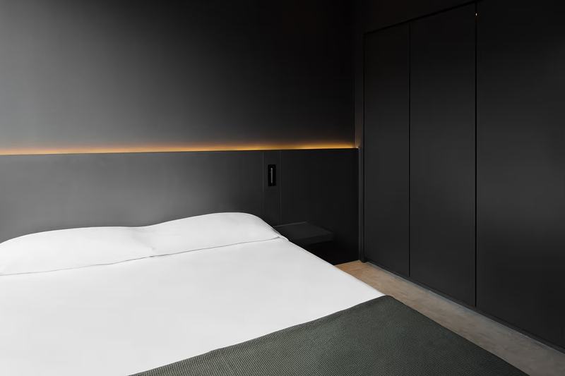 Grey House townhouse: bedroom with wardrobes and headboard lighting