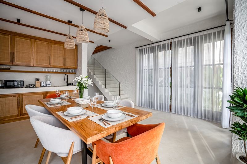 Tropical Tribe: kitchen and dining table by the stairs to the upper floor
