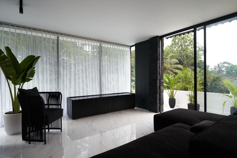 Two-story villa in Ubud: upstairs lounge with windows onto the jungle