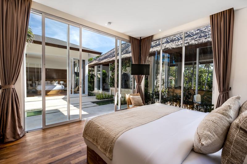 Four-bedroom villa in Sayan, Ubud: bedroom with glass walls