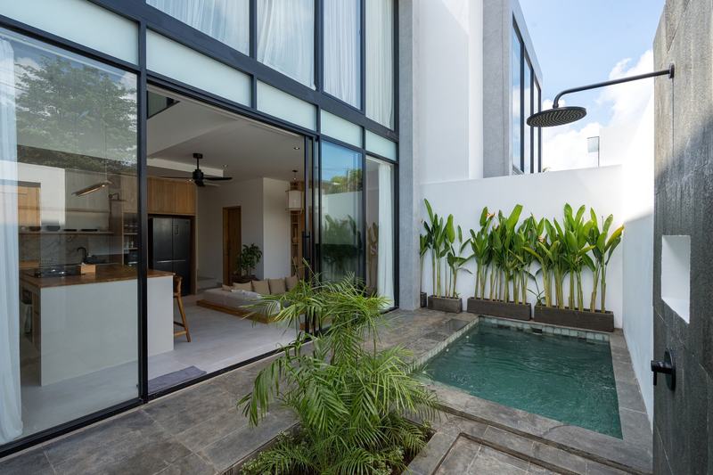 One-bedroom villa in west Uluwatu: pool with the living room behind glass