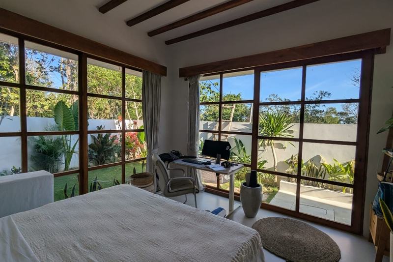 One-bedroom villa in east Uluwatu: bedroom with floor-to-ceiling windows onto the garden