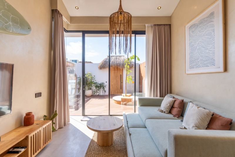 One-bedroom villa with PBG at Nyang Nyang: living room opening to the yard