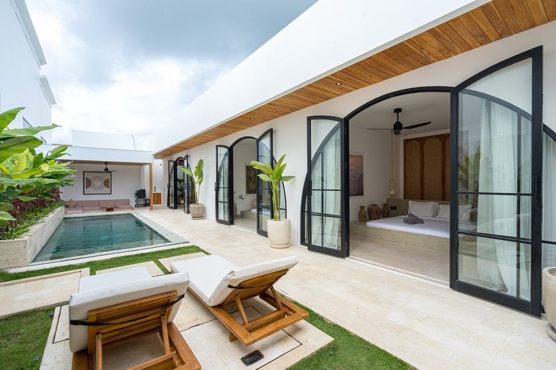 Two-bedroom villa at Nyang Nyang, Uluwatu: pool and bedroom with arched doors